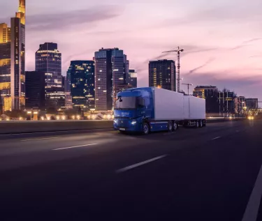 Renault Trucks E-Tech T equipped with CMS (Camera Monitoring System) instead of rear-view mirrors, driving in the city at night